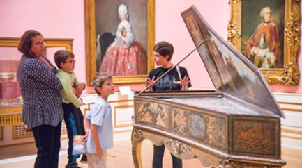 A family looking at a piano