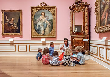 Photo of a woman with a group of children. Links to Link to Life Stage Gift Planner Under Age 60 Situations.