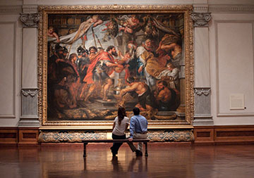 Photo of a couple looking at a painting. Links to Tangible Personal Property